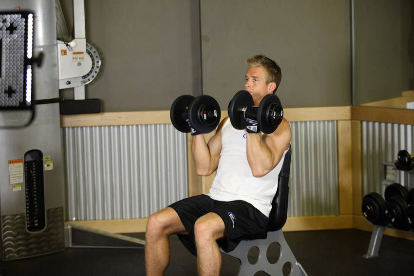 Arnold Press exercise demonstration, targeting the shoulders