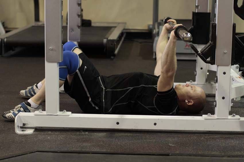 Barbell Floor Press exercise demonstration, targeting the chest
