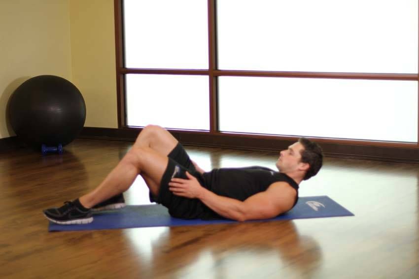 Figure-Four Glute Stretch exercise demonstration — targets the glutes