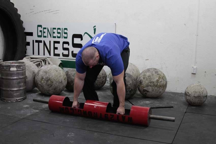 Log Clean and Press exercise demonstration — targets the shoulders