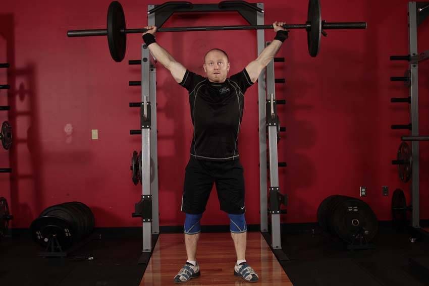Overhead Squat exercise demonstration — targets the quads