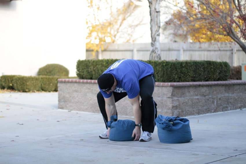 Sandbag Load exercise demonstration — targets the quads